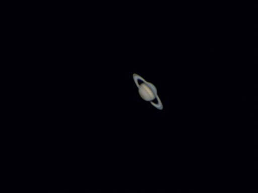 Saturn with its iconic rings against a dark background.